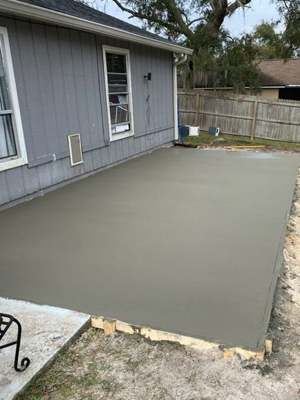 Backyard concrete slab for screened patio Deltona Florida